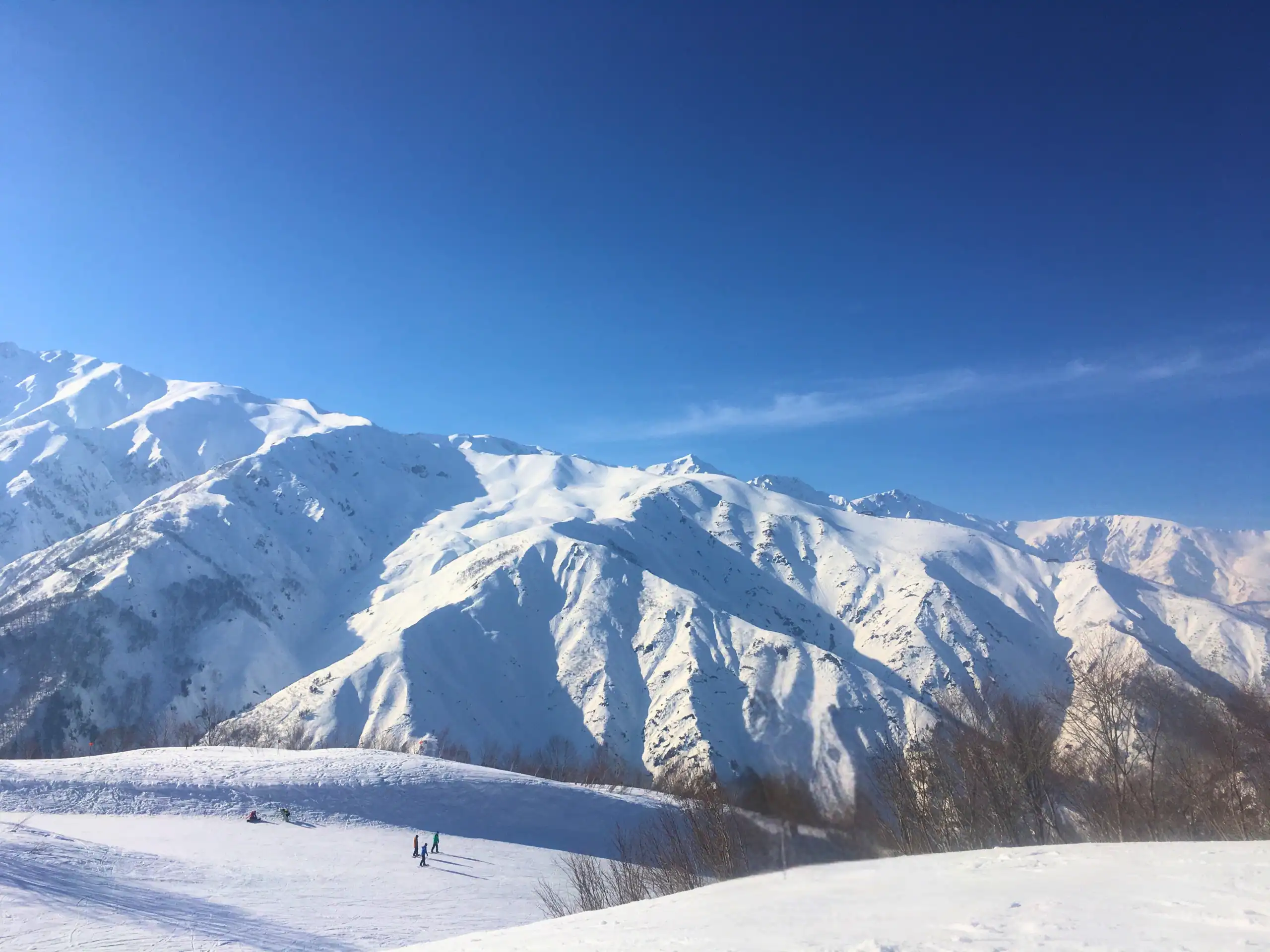 Snow-covered mountains set against blue skies at Hakuba
